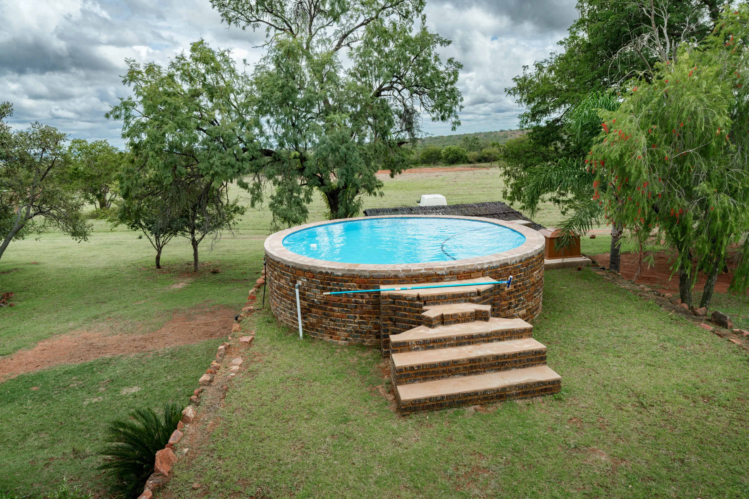 Impala Game Ranch pool overlooking the bush at golden hour
